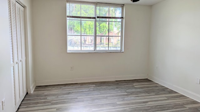 empty room featuring light wood-style flooring and baseboards