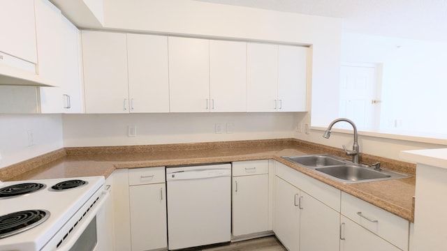 kitchen with white appliances, light wood finished floors, light countertops, white cabinetry, and a sink