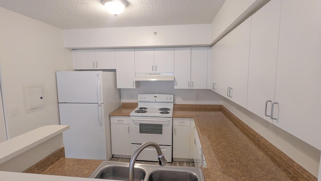 kitchen with white appliances, white cabinetry, a sink, and under cabinet range hood