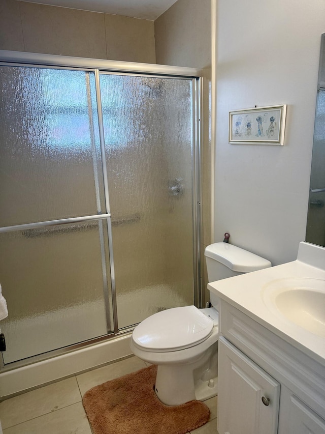 full bath featuring toilet, a stall shower, tile patterned flooring, and vanity