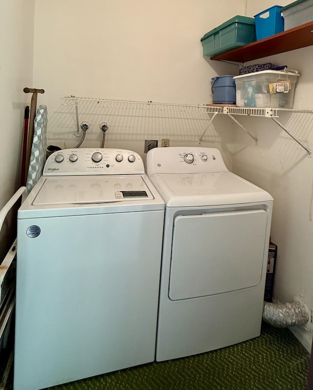 washroom featuring separate washer and dryer and laundry area