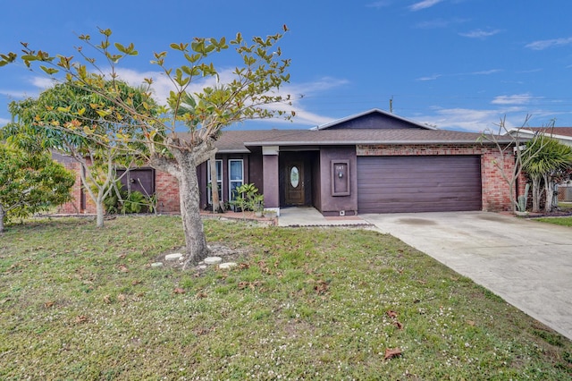 single story home with an attached garage, driveway, and a front yard