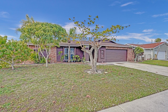 ranch-style home featuring driveway, an attached garage, and a front yard