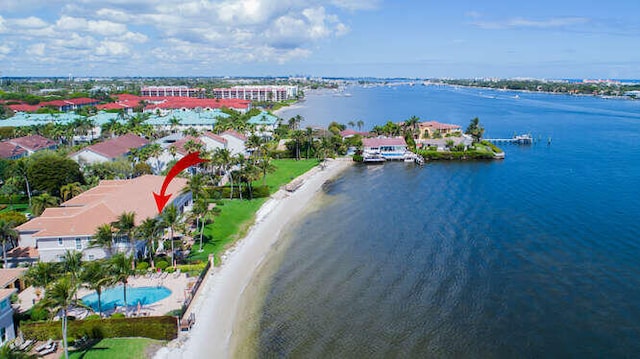 birds eye view of property featuring a water view and a beach view