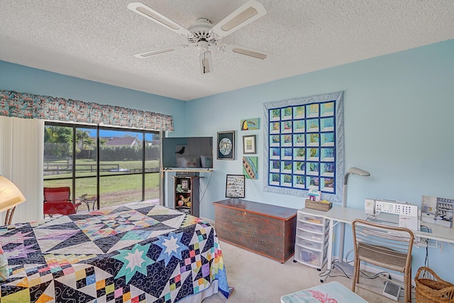 bedroom with a textured ceiling, access to outside, carpet flooring, and a ceiling fan