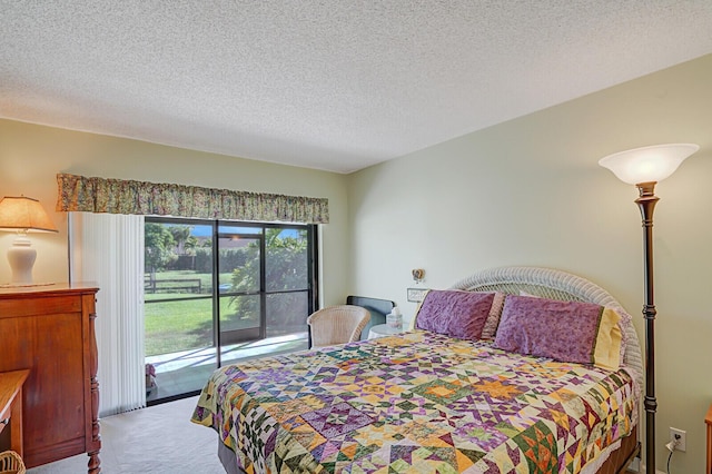 carpeted bedroom featuring access to outside and a textured ceiling