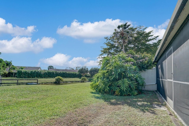 view of yard with a rural view and fence