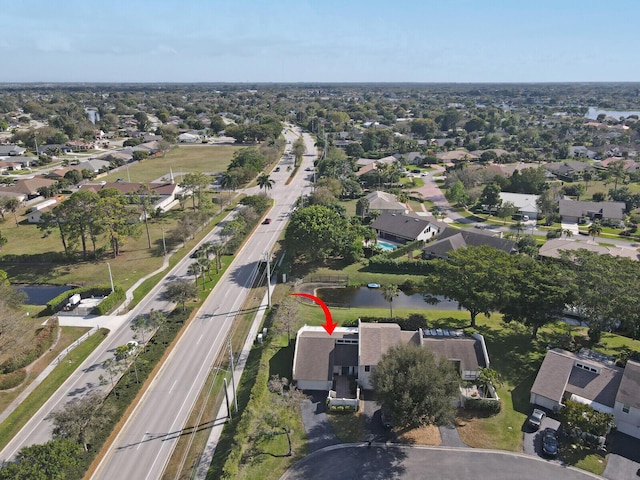 birds eye view of property with a residential view and a water view