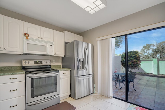 kitchen with light tile patterned floors, white cabinetry, and stainless steel appliances