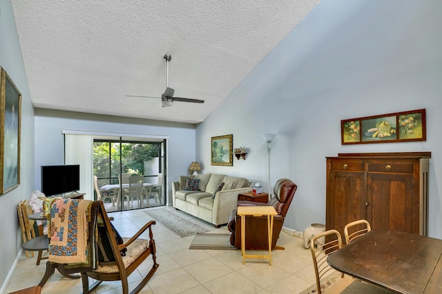 living area with light tile patterned floors, ceiling fan, a textured ceiling, and high vaulted ceiling