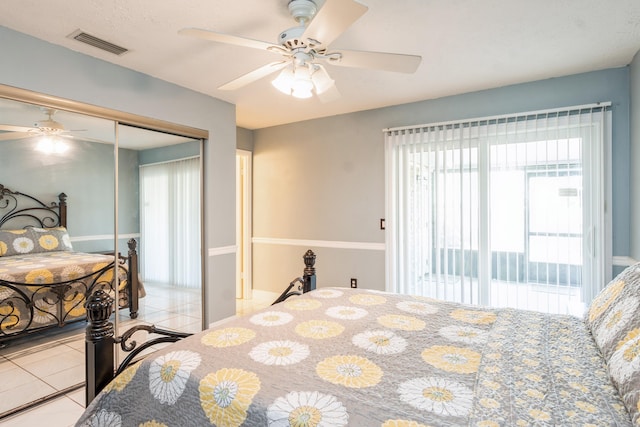 bedroom with a ceiling fan, a closet, visible vents, and light tile patterned floors