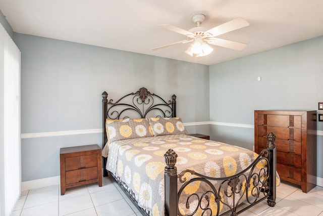 bedroom with light tile patterned floors, ceiling fan, and baseboards