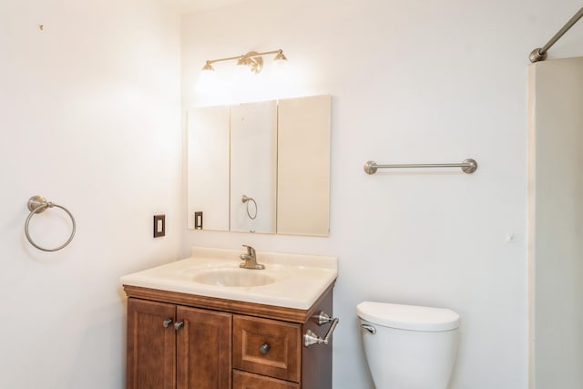 bathroom with toilet and vanity