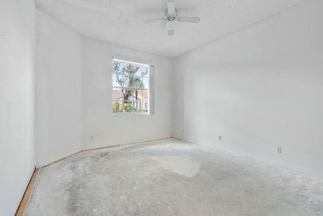 unfurnished room with concrete flooring, a ceiling fan, and a textured ceiling