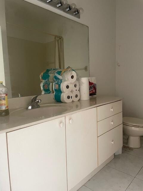 bathroom with vanity, toilet, and tile patterned floors