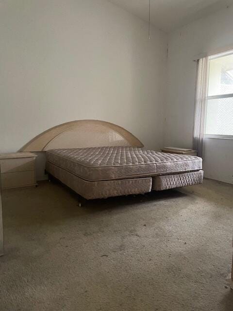 carpeted bedroom featuring lofted ceiling