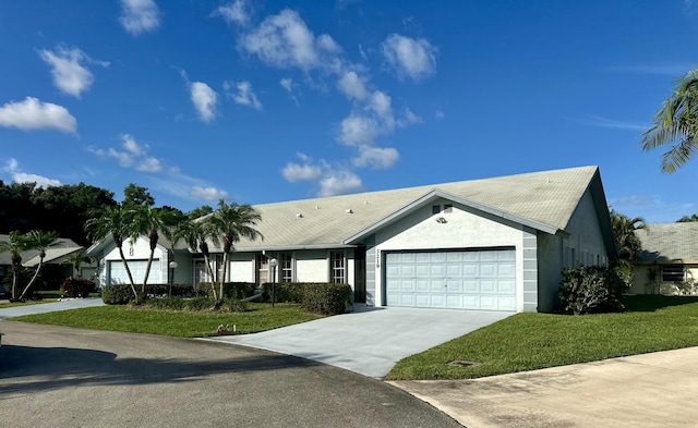 ranch-style house with a garage, stucco siding, driveway, and a front yard