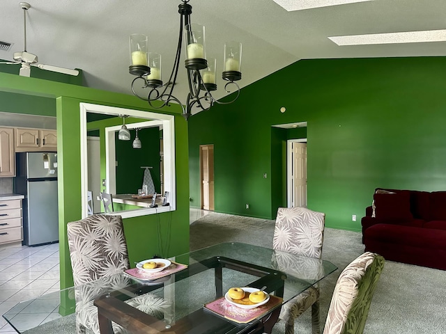 living area with light tile patterned floors, visible vents, lofted ceiling with skylight, light carpet, and ceiling fan with notable chandelier