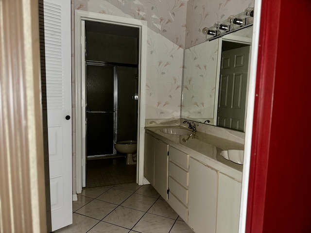 full bath featuring tile patterned floors, a sink, toilet, and wallpapered walls