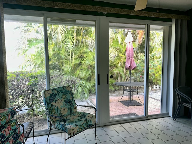 doorway to outside featuring ceiling fan