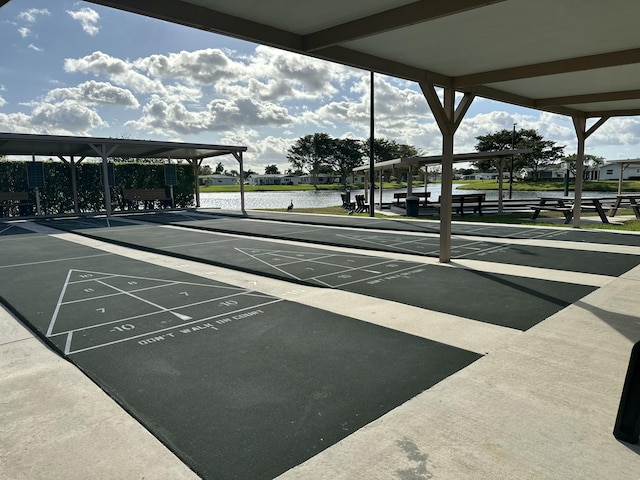 surrounding community featuring shuffleboard and a water view