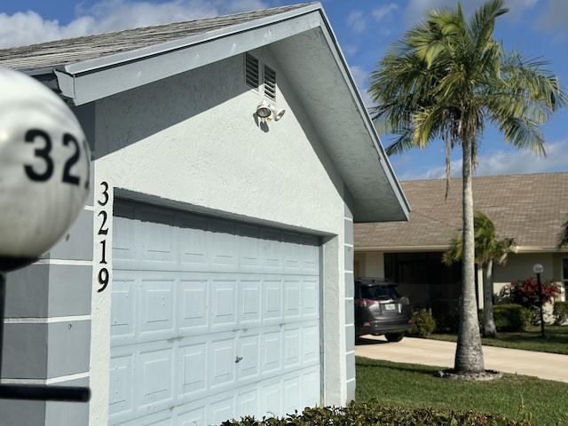 garage with concrete driveway