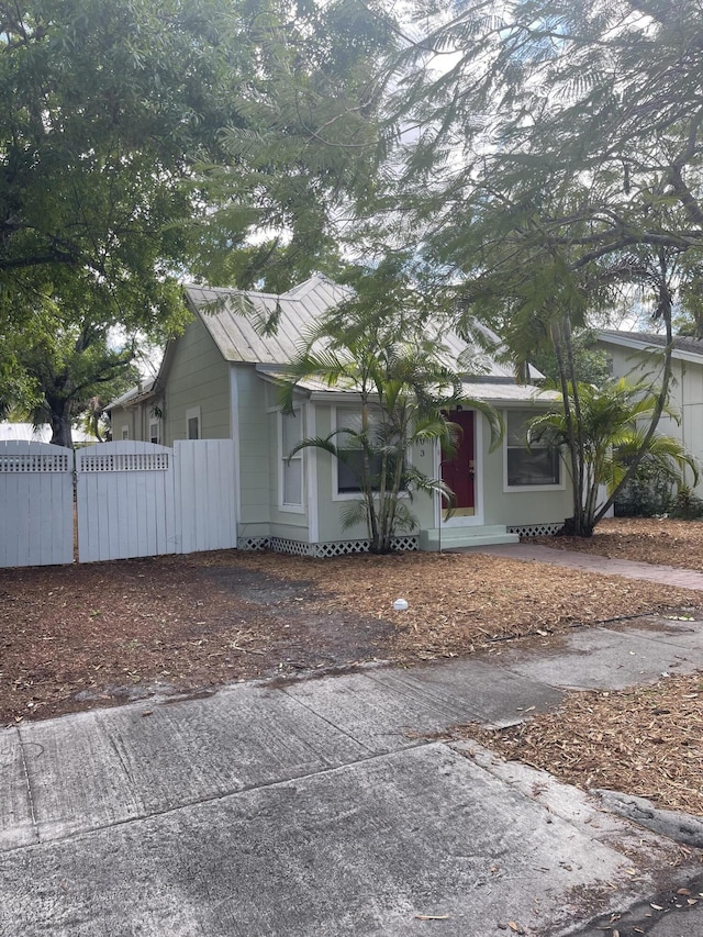 ranch-style house featuring fence