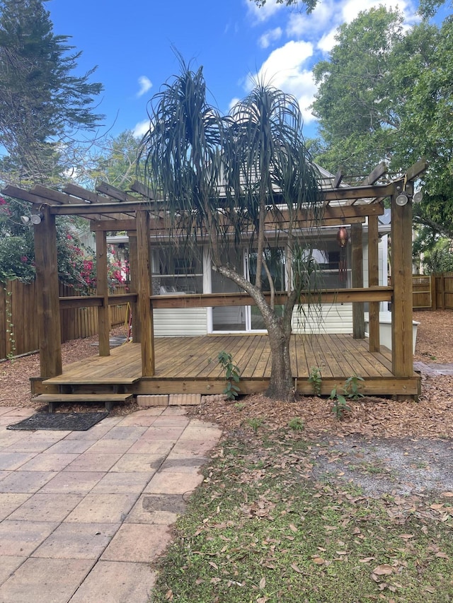 exterior space featuring fence and a deck