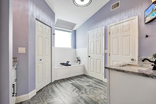 full bath with lofted ceiling, vanity, visible vents, and a bath