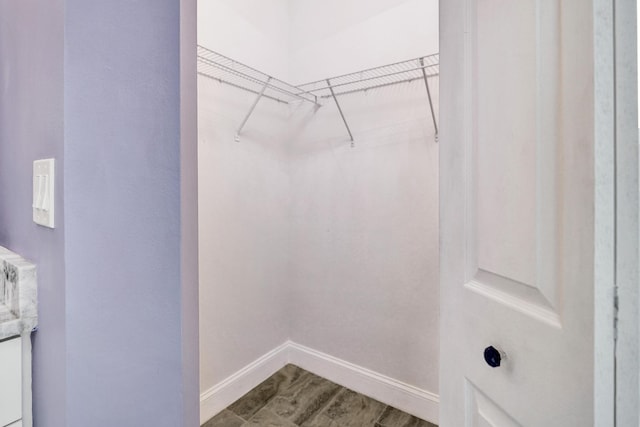 walk in closet featuring wood finished floors