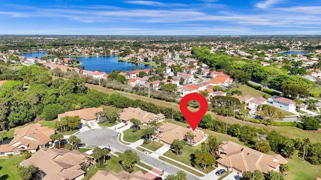 birds eye view of property with a water view and a residential view