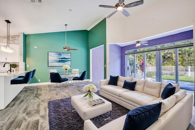 living area featuring high vaulted ceiling, ceiling fan, and baseboards