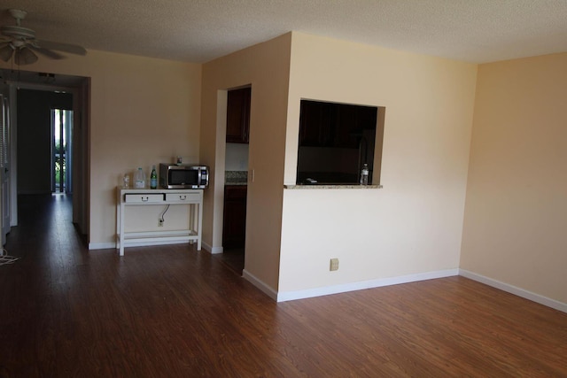 unfurnished room featuring dark wood-style floors and a textured ceiling