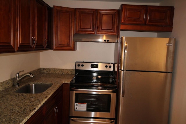 kitchen featuring stainless steel appliances, a sink, under cabinet range hood, and light stone countertops