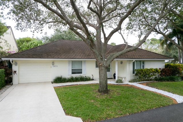 ranch-style house featuring concrete driveway, stucco siding, an attached garage, and a front yard