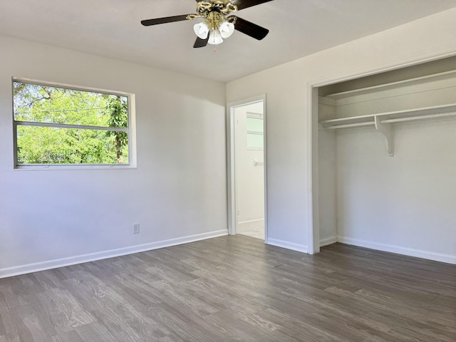 unfurnished bedroom featuring ceiling fan, a closet, wood finished floors, and baseboards