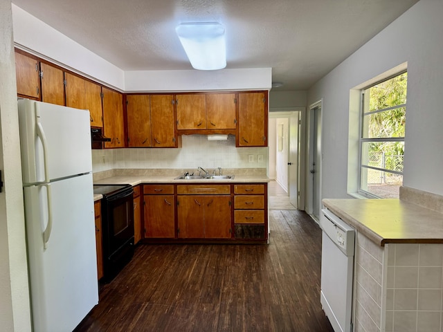 kitchen featuring light countertops, white appliances, ventilation hood, and a sink