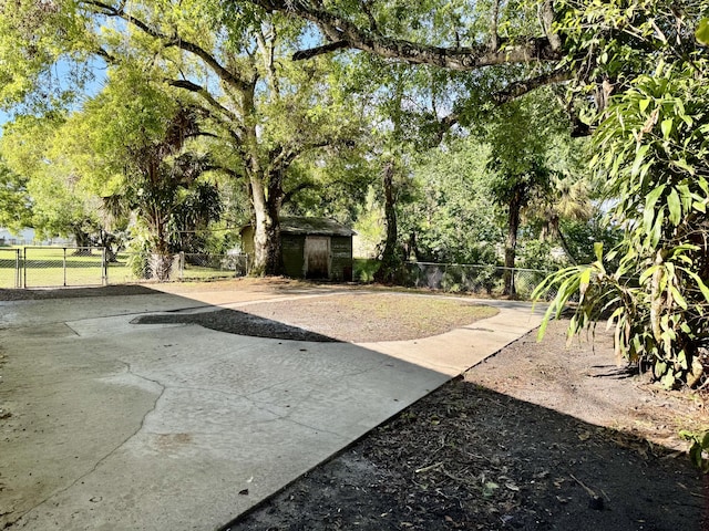 view of yard with an outbuilding, a fenced backyard, and a storage shed