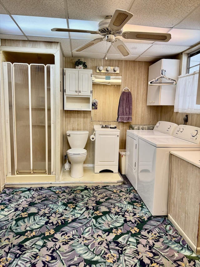 laundry area featuring laundry area, washer and clothes dryer, and wooden walls