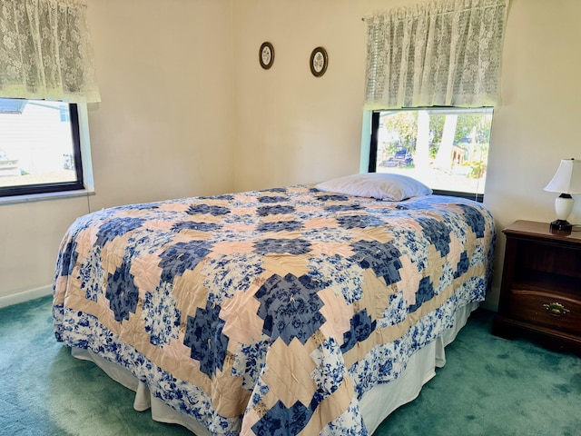 bedroom featuring carpet floors and baseboards