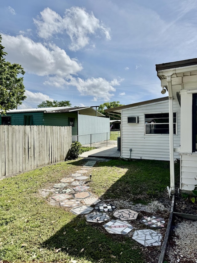 view of yard featuring an attached carport and fence