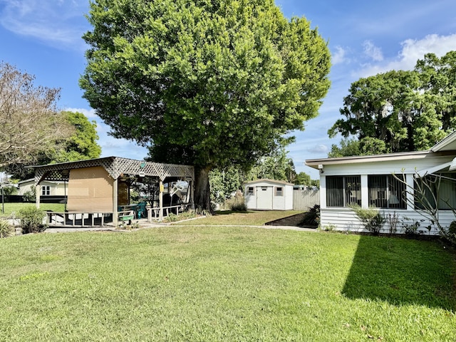 view of yard featuring a shed and an outdoor structure