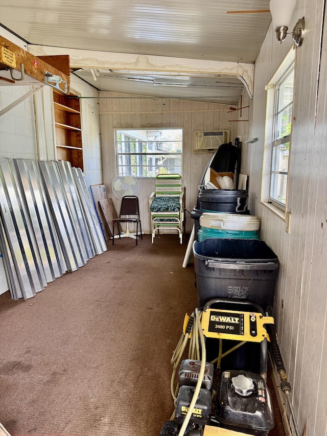 garage featuring wood walls and a wall mounted AC