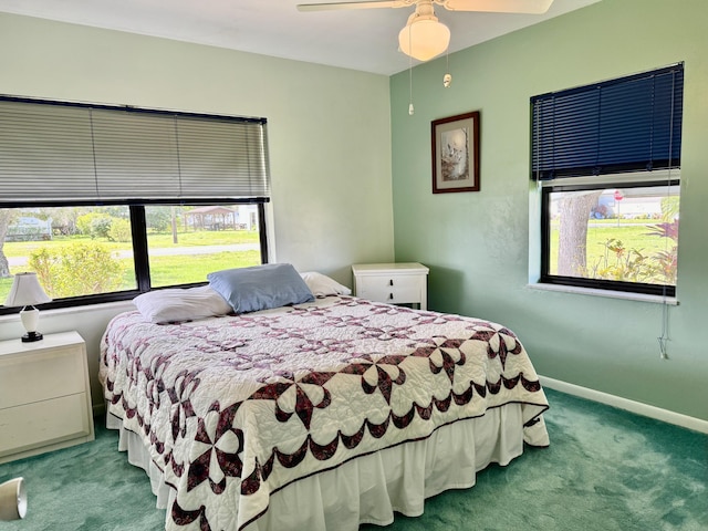 carpeted bedroom featuring a ceiling fan and baseboards