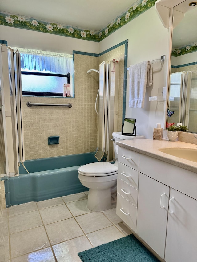 full bath with toilet, tile patterned flooring, washtub / shower combination, and vanity