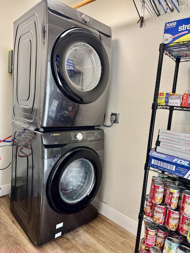 2532 NW 33rd Ave, Okeechobee, FL 34972 - laundry room with laundry area, wood finished floors, baseboards, and stacked washer / drying machine