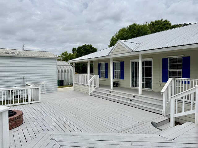 2532 NW 33rd Ave, Okeechobee, FL 34972 - wooden deck with covered porch and a fire pit