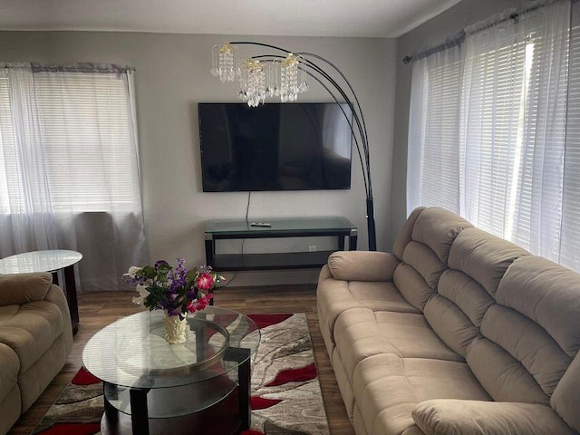 living area featuring a notable chandelier and wood finished floors