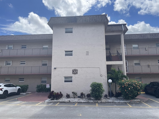 view of building exterior featuring uncovered parking