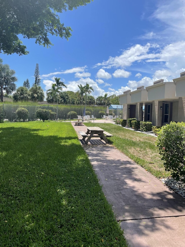 view of community featuring a patio area and a yard